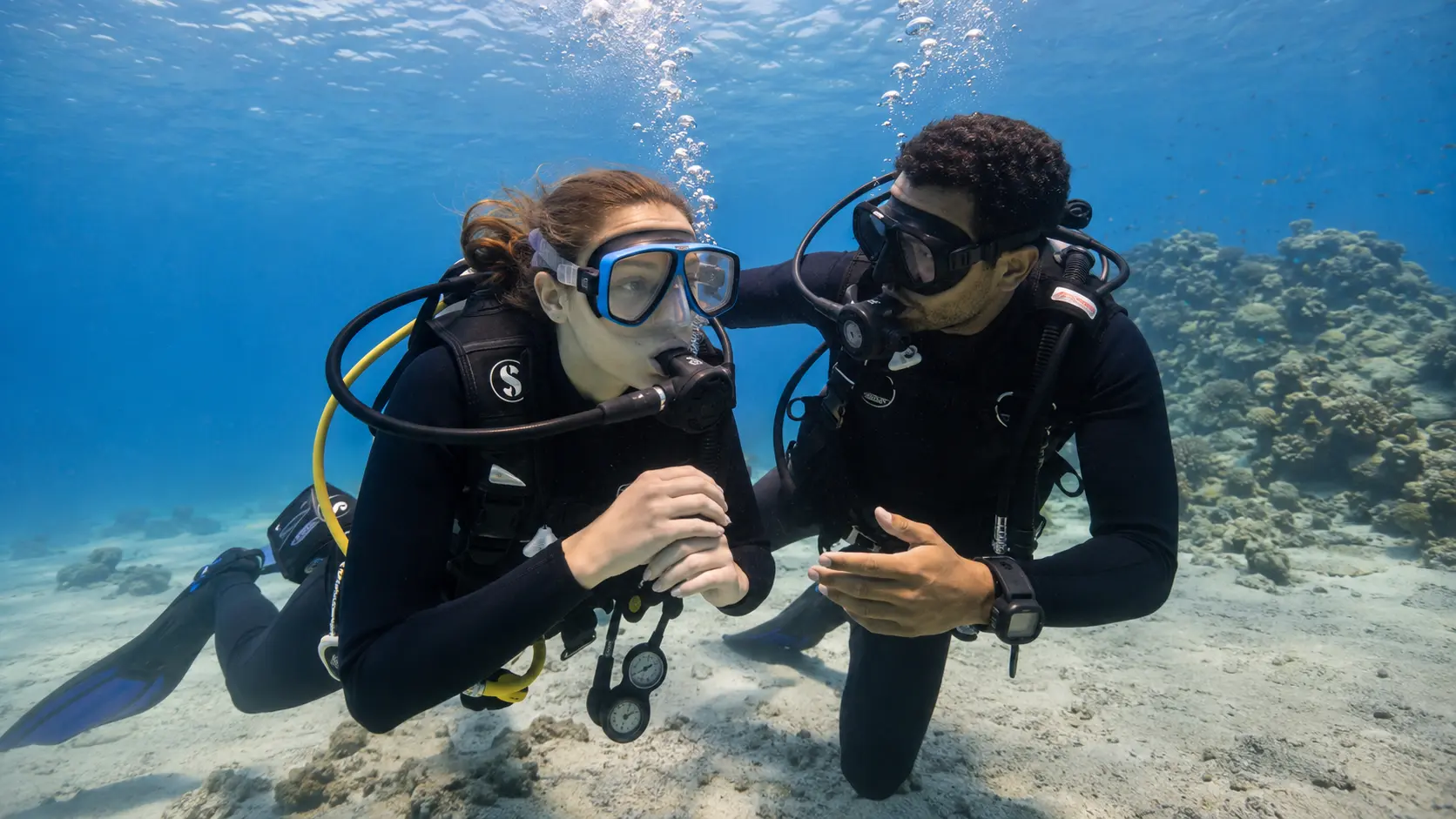 First-time scuba diver with an instructor in shallow Red Sea water near Hurghada